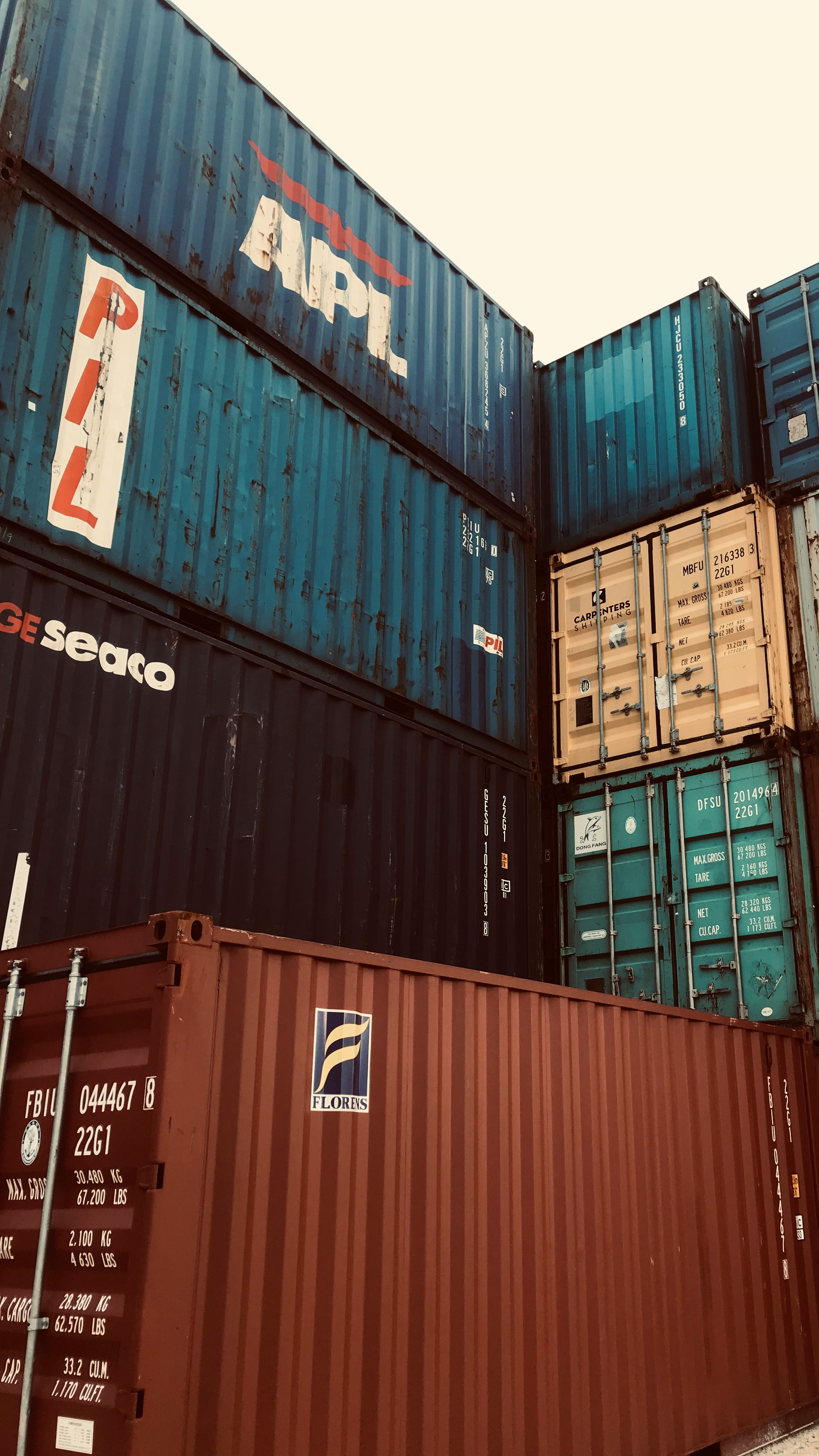 a bunch of cargo containers stacked on top of each other